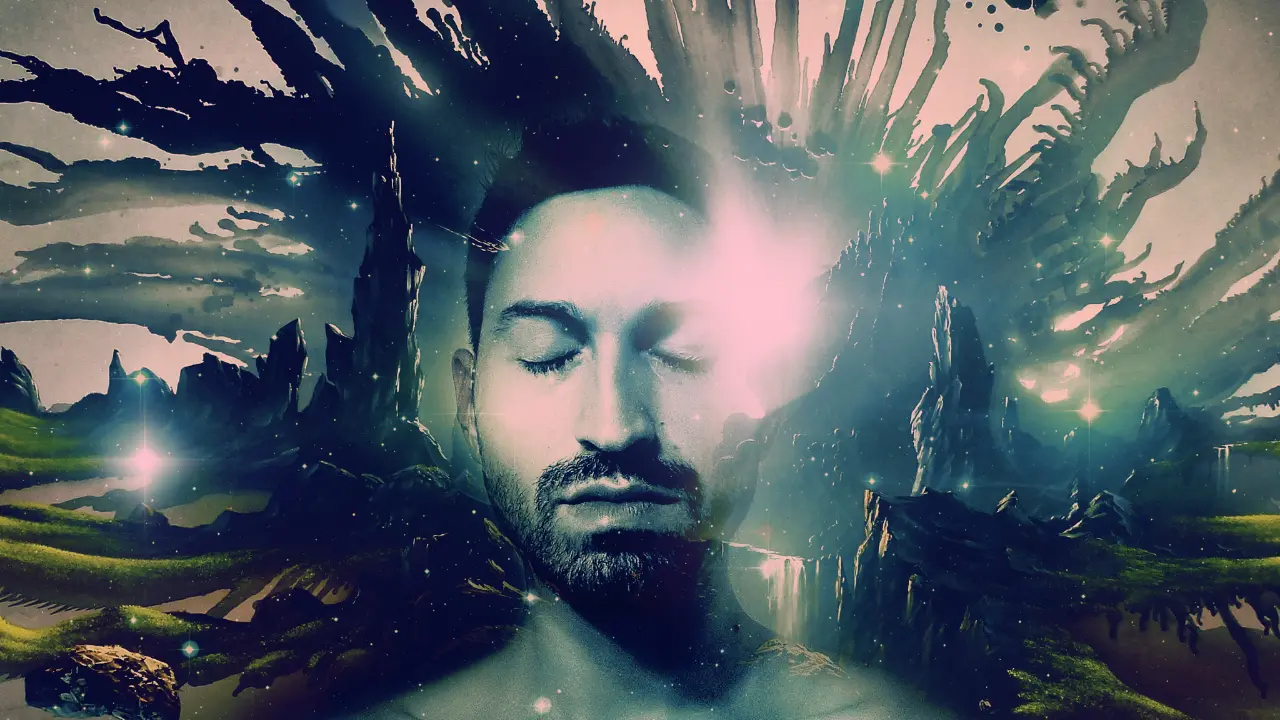 A man's eyes are closed while an ethereal colorful landscape bursts around him.