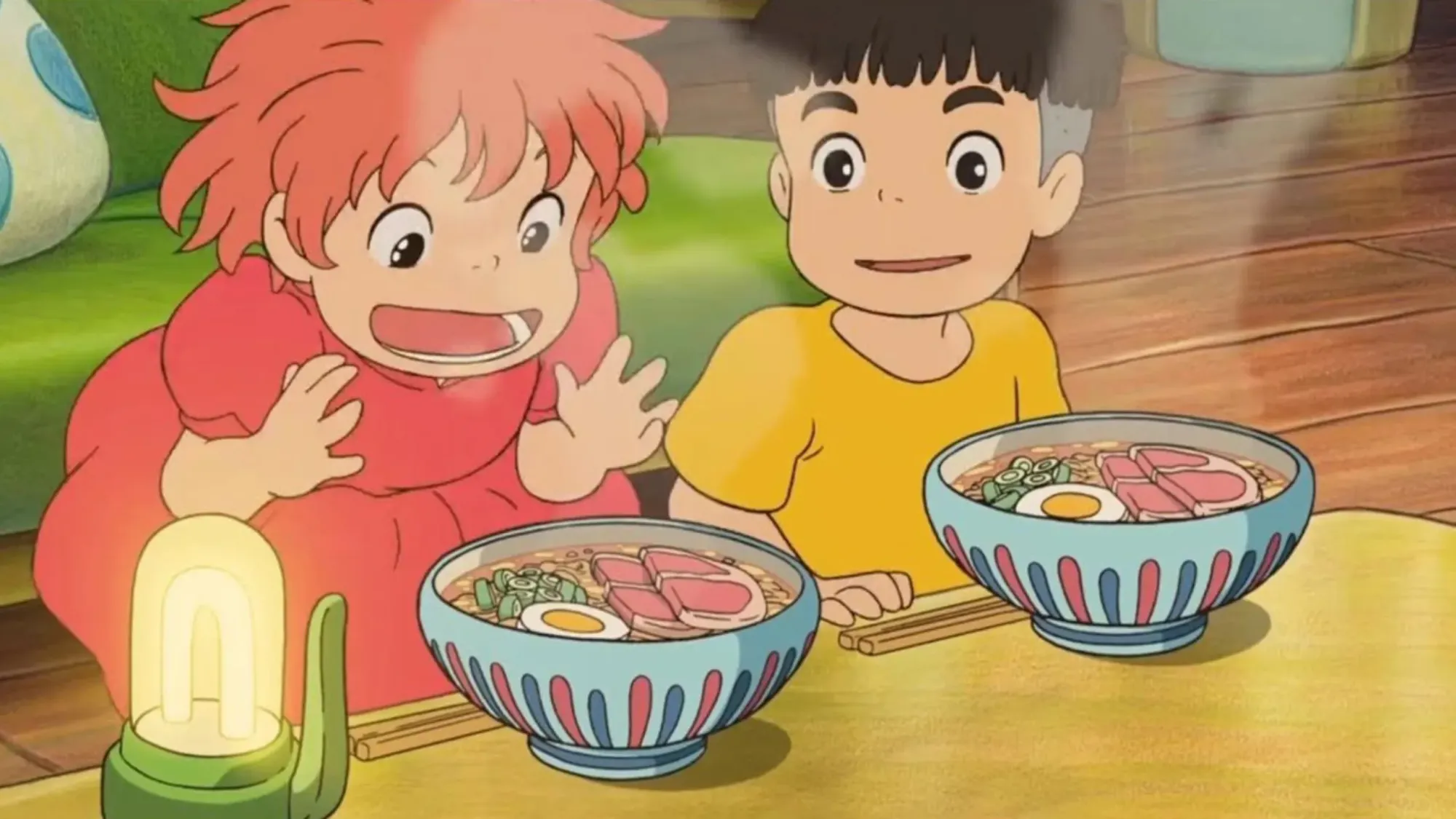 Animated characters look excited as they are about to eat bowls of ramen, from the film, "Ponyo".